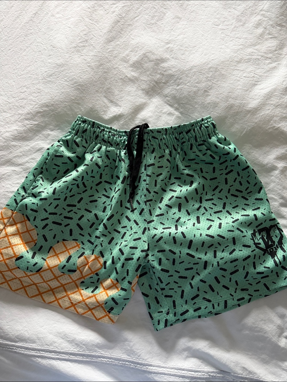 Kids Mint Green Patterned Swim Shorts with Orange Accent
